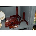 A selection of oriental hardwood display stands and folding plate racks, the largest stand