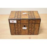 A Victorian walnut parquetry inlaid tea caddy, with double compartmented interior, key, and