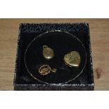 Two rolled gold lockets one of heart shaped form, a white metal bangle and a hallmarked gold pendant