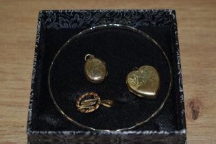 Two rolled gold lockets one of heart shaped form, a white metal bangle and a hallmarked gold pendant