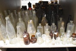 A large collection of vintage bottles, including advertising bottles of interest to Carlisle and