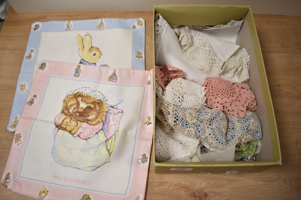 A selection of vintage doyleys and two Beatrix potter cushion covers.