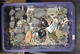A box full of pebbles, shards of pottery and sea glass.