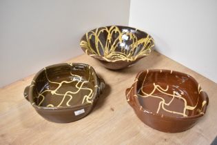 Three items of drip glazed terracotta, including bowl and two casserole dishes, in the manner of