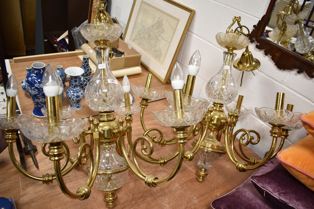 Two modern brass and glass six stemmed chandelier ceiling lights.