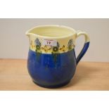 An early 20th Century Brannam Barum Ware pottery jug, decorated in a blue and cream glaze, measuring