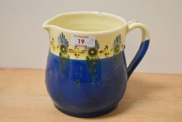 An early 20th Century Brannam Barum Ware pottery jug, decorated in a blue and cream glaze, measuring