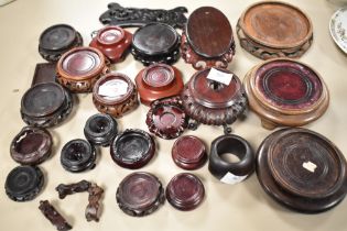 A collection of carved and turned treen vase stands.