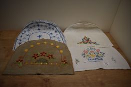 Three 1930s embroidered tea cosies, the largest measures 40cm long