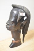 A heavy and intricately carved heavy hardwood African bust.