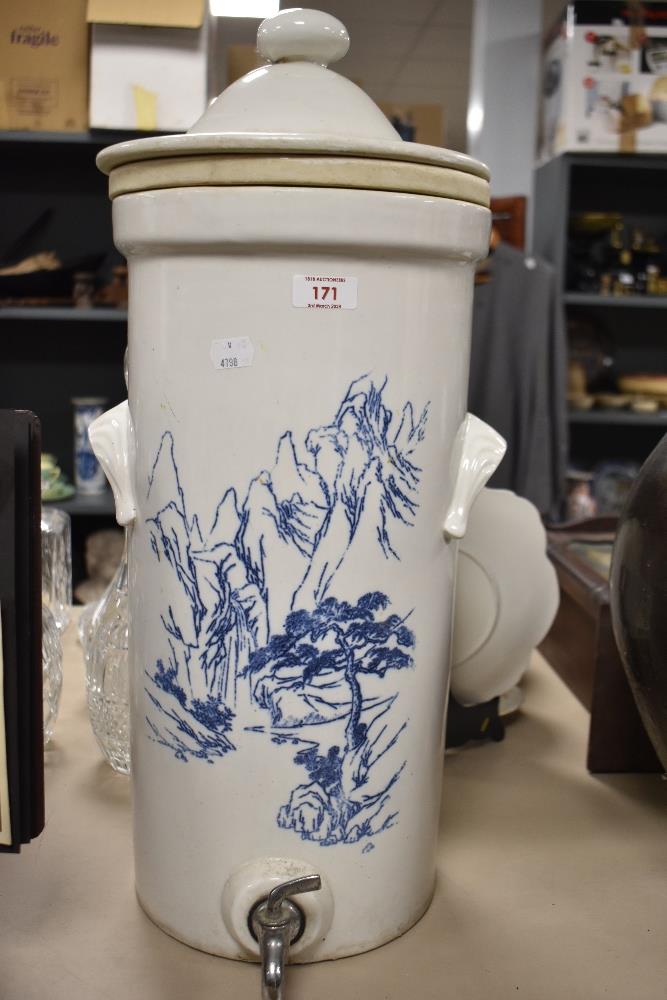 A large glazed earthenware beverage dispenser, having white ground with oriental scene in blue