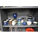 A collection of Wetheriggs Pottery, Penrith, jugs, bowls, condiment pots and mugs, having swirled