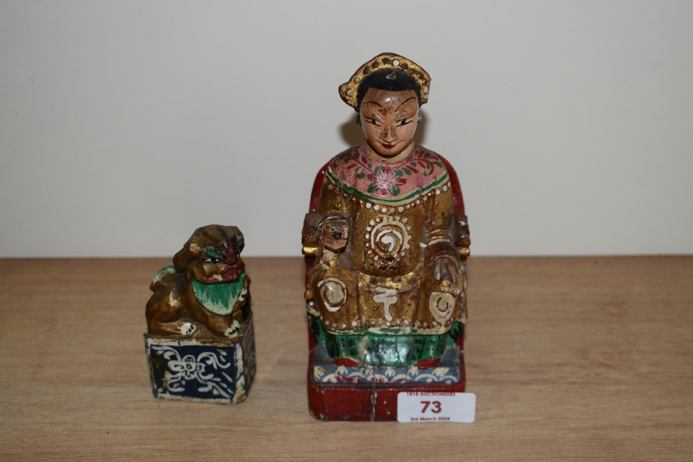 A Chinese carved and polychrome painted wooden figurine and a dog of Foo.