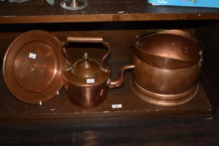 A copper coal helmet with brass handle, a copper charger and a copper kettle.