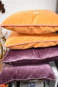 Two mauve velvet Laura Ashley cushions with feather liners and two orange velvet cushions, with pink