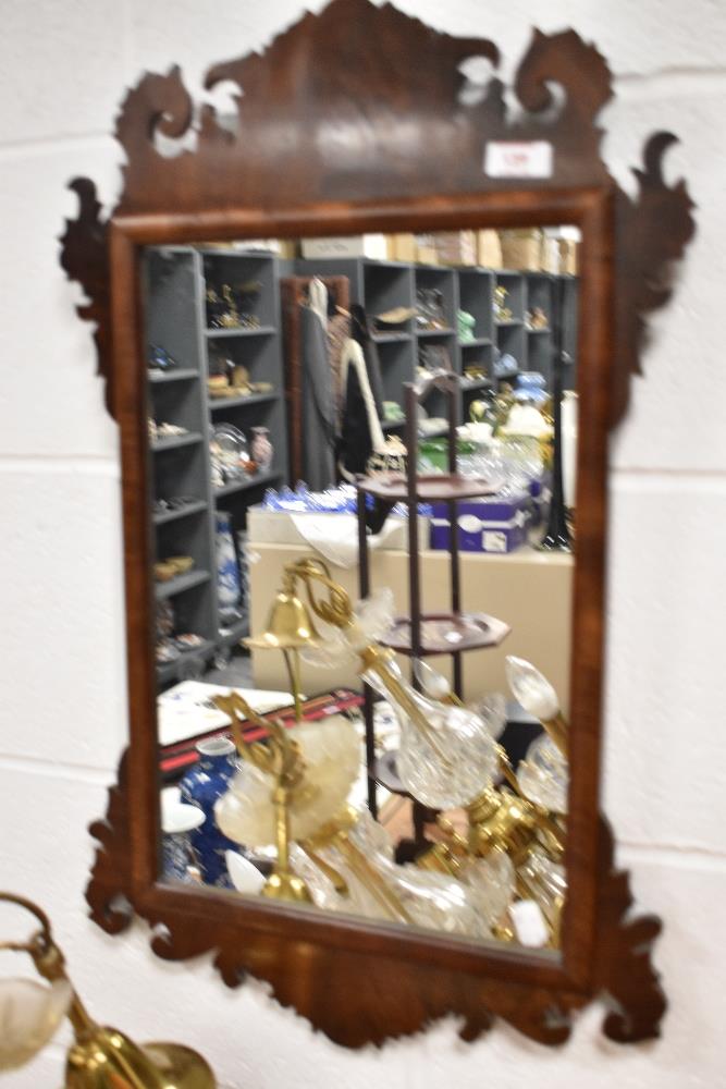 A 19thearly 20th century fret-framed Chippendale style wall mirror.