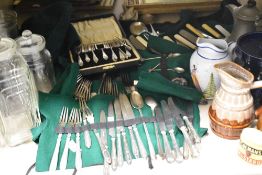 A variety of glass storage jars, cutlery, including bone handled knives and a selection of mixed