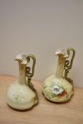 A pair of early 20th century Vienna porcelain ewers, having twist handle and poppy decoration with