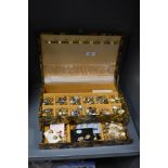 A jewellery box containing assorted costume jewellery, to include gold coloured and enamelled