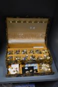 A jewellery box containing assorted costume jewellery, to include gold coloured and enamelled