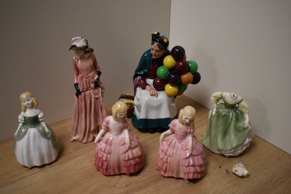 A Royal Doulton bone china figurine 'The Old Balloon Seller' HN1351, sold along with two Rose