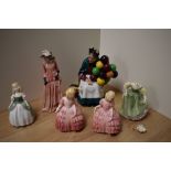 A Royal Doulton bone china figurine 'The Old Balloon Seller' HN1351, sold along with two Rose