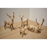 A Beswick Pottery deer family, comprising Stag standing number 981, Stag lying number 954, Doe