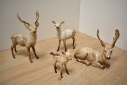 A Beswick Pottery deer family, comprising Stag standing number 981, Stag lying number 954, Doe