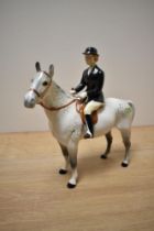 A Beswick Pottery Huntswoman, model number 1730, style two, rider and horse stood still, designed by