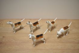 A group of five Beswick Pottery foxhounds, models 2262 x3 and 2265 both designed by Graham Tongue in
