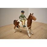 A Beswick Pottery 'Girl on Skewbald Pony' model number 1499, designed by Arthur Gredington,