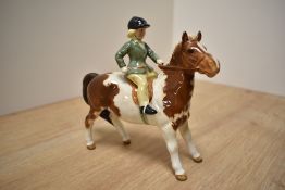 A Beswick Pottery 'Girl on Skewbald Pony' model number 1499, designed by Arthur Gredington,