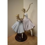 A large and Lladro porcelain figural group, 'Merry Ballet' formed as two ballerinas, one mid-jump,