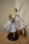 A large and Lladro porcelain figural group, 'Merry Ballet' formed as two ballerinas, one mid-jump,