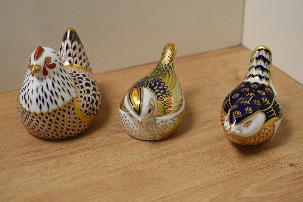 A group of three Royal Crown Derby Imari pattern bird-form paperweights, comprising a seated