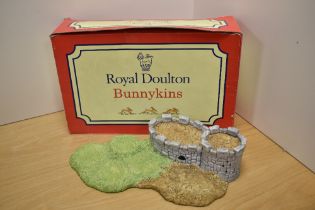A Royal Doulton Bunnykins 'Robin Hood Collection' castle form display stand, with original