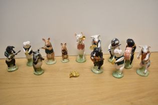 A collection of twelve Beswick Pottery 'Pig Promonade' anthropomorphic band members, some marked