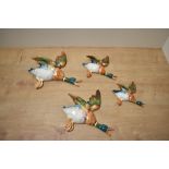 A group of four graduating Beswick Pottery flying mallard wall plaques, 596-1 (repair to wing) 596-