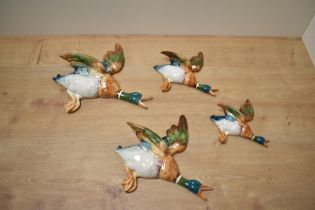 A group of four graduating Beswick Pottery flying mallard wall plaques, 596-1 (repair to wing) 596-