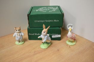 A group of three Beswick Pottery Beatrix Potter figures, comprising Tom Kitten, Peter Rabbit and