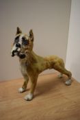 A contemporary studio pottery boxer dog study with mottled earthy toned glaze replicating brindle