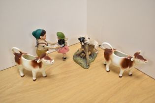 A Border Fine Arts Jack Russell Terrier and Rabbit group, a pair of ceramic cow creamers, each