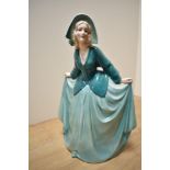 A German Art Deco Katzhutte Porcelain figurine, depicting gril in flowing green dress, printed