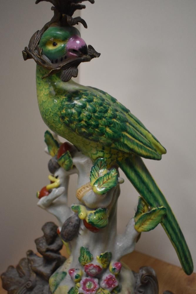 An attractive cast gilt metal and porcelain candlestick, formed as a perched parrot holding a - Image 2 of 2