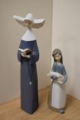 A Lladro porcelain nun figurine number 5500 Prayerful Moment, 26cm sold along with a Lladro