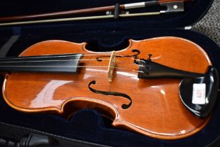 A traditional violin having 14inch two piece bag with figure head to scroll with bow and modern