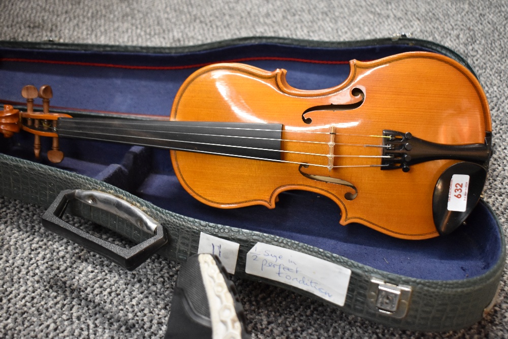 A modern half size violin labelled Stentor , made in Romania, with bow and croc effect case