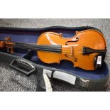 A modern half size violin labelled Stentor , made in Romania, with bow and croc effect case
