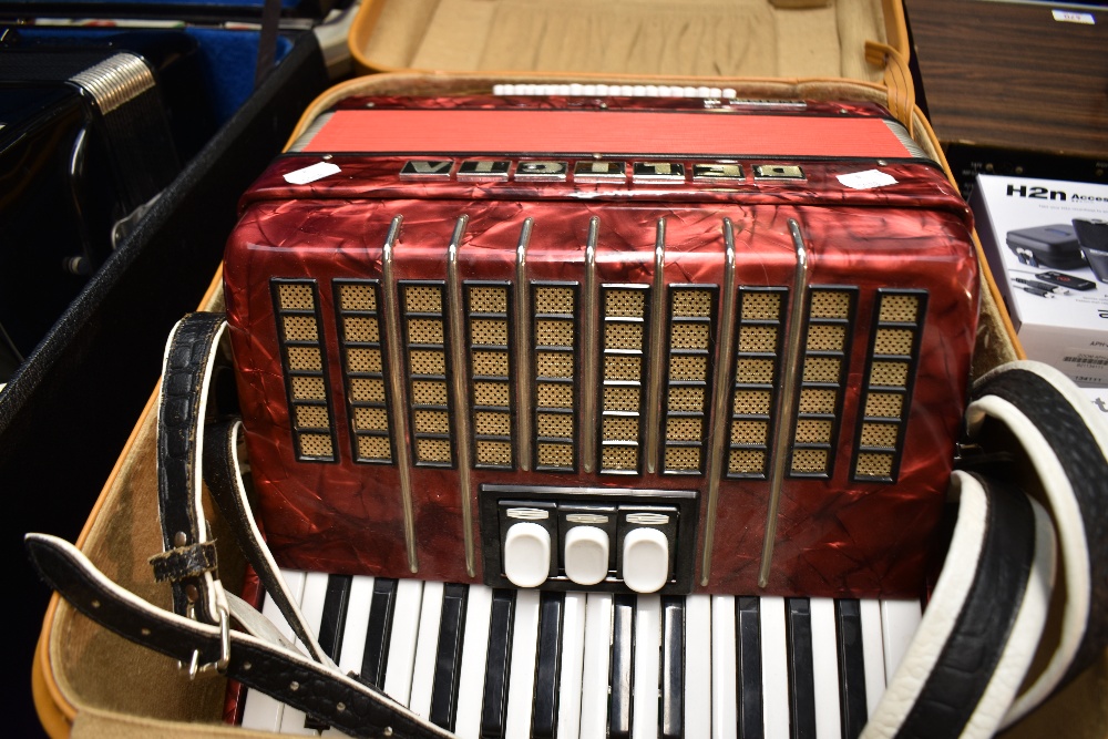 A Delicia Junior accordion , with case