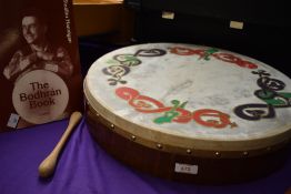 A traditional Bodhran with beater and book